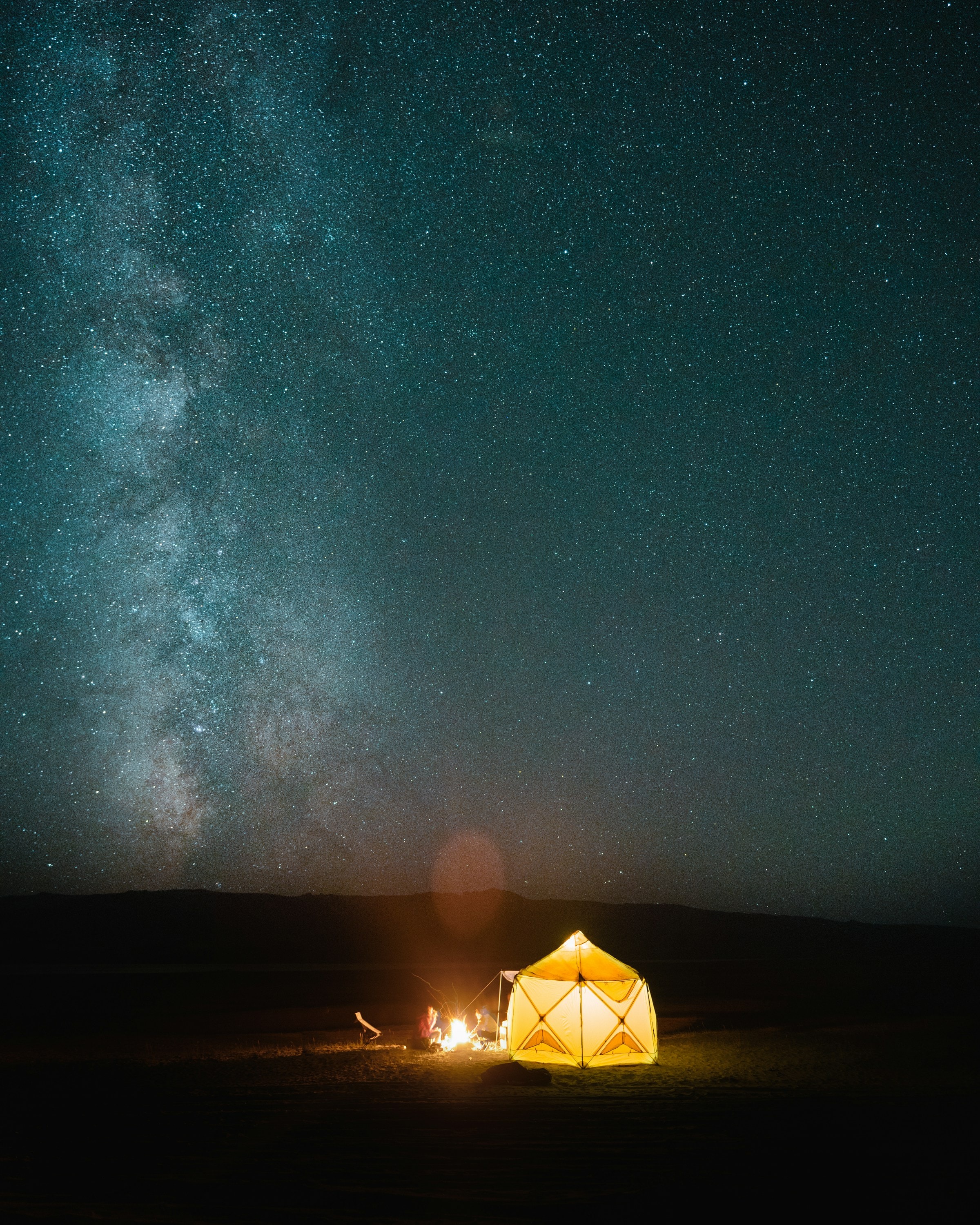 Illuminated tent under the Milky Way from the project archive