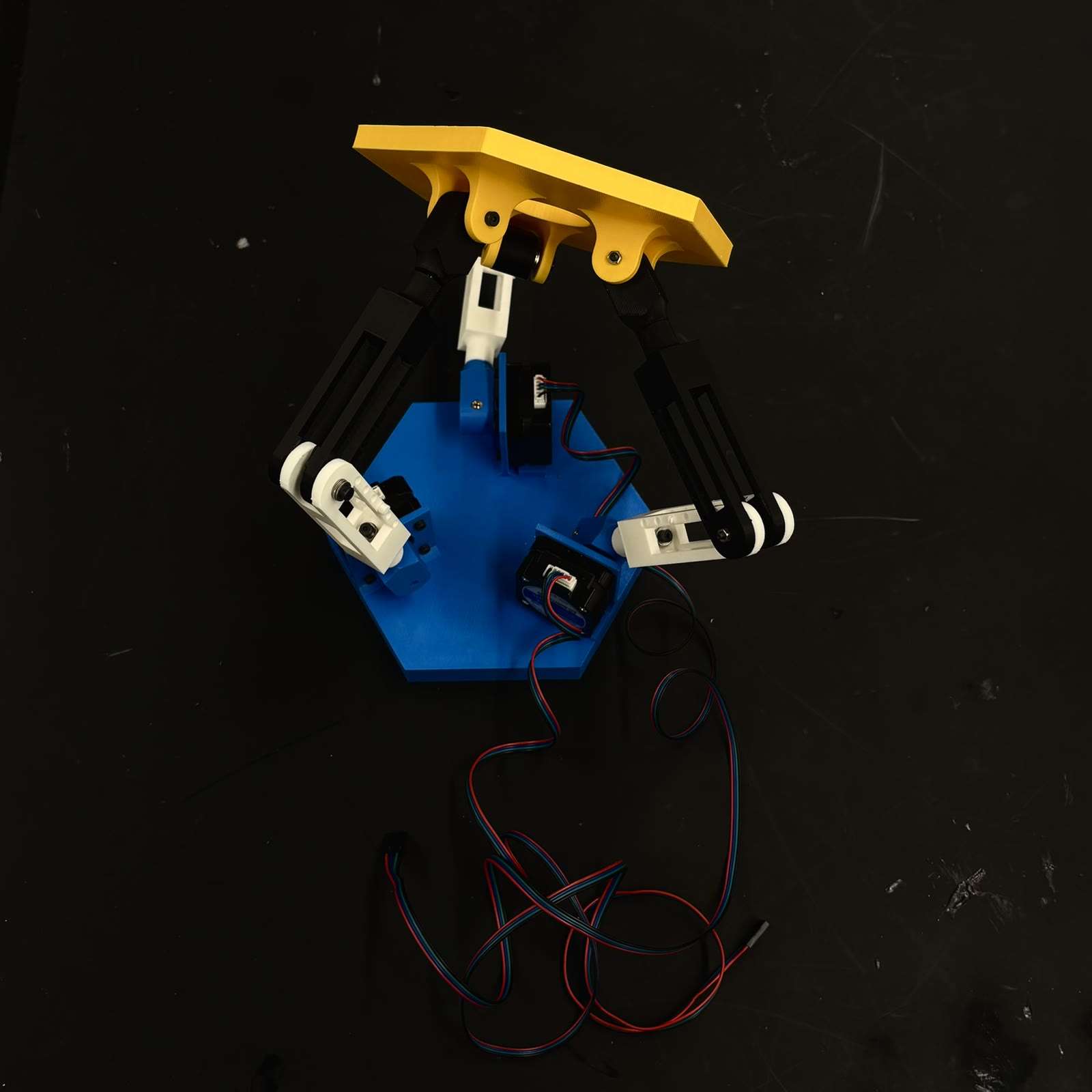 HALO’s assembled three-arm mechanism — printed links, motor mounts, and moving platform