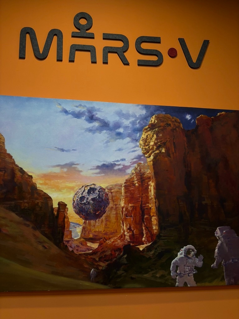 Mars exploration artwork displayed beneath MARS-V signage